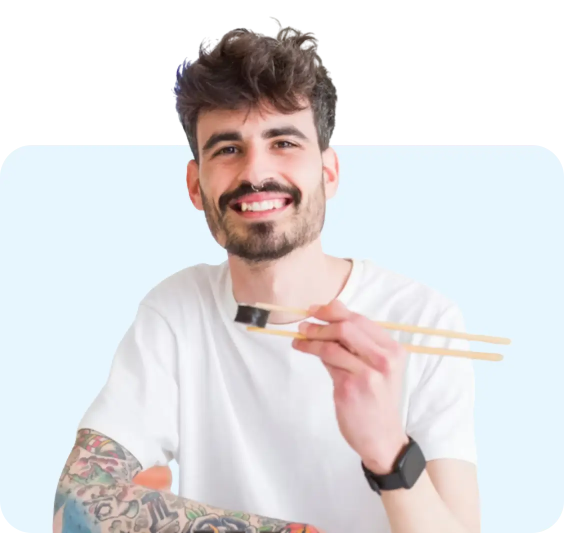 man eating sushi with chopsticks